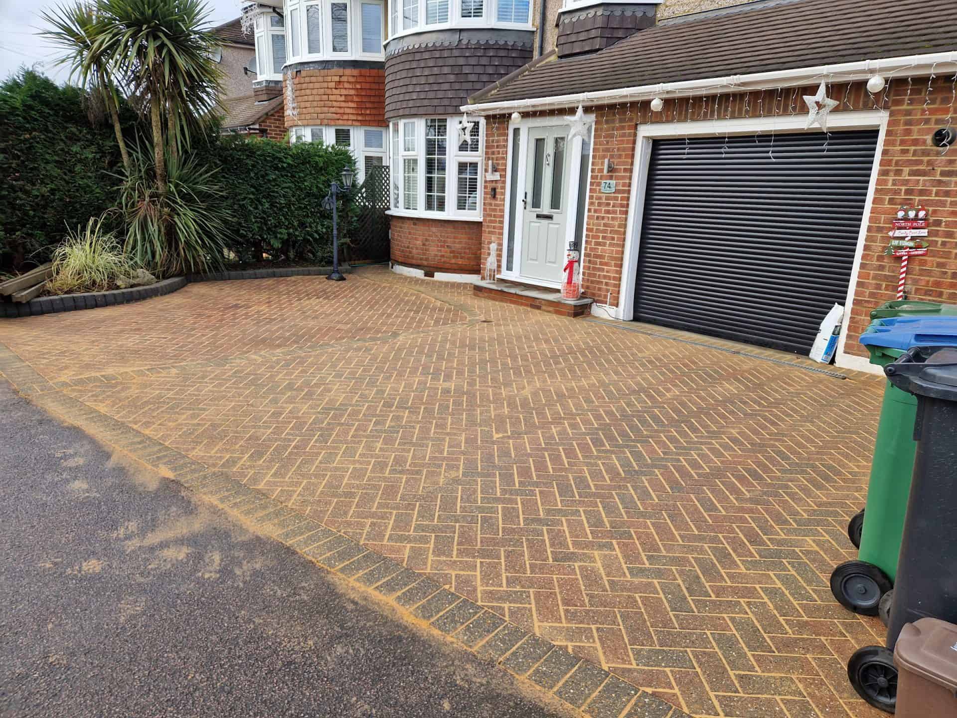 The same block paved driveway after cleaning, the herringbone paving back to its original colour