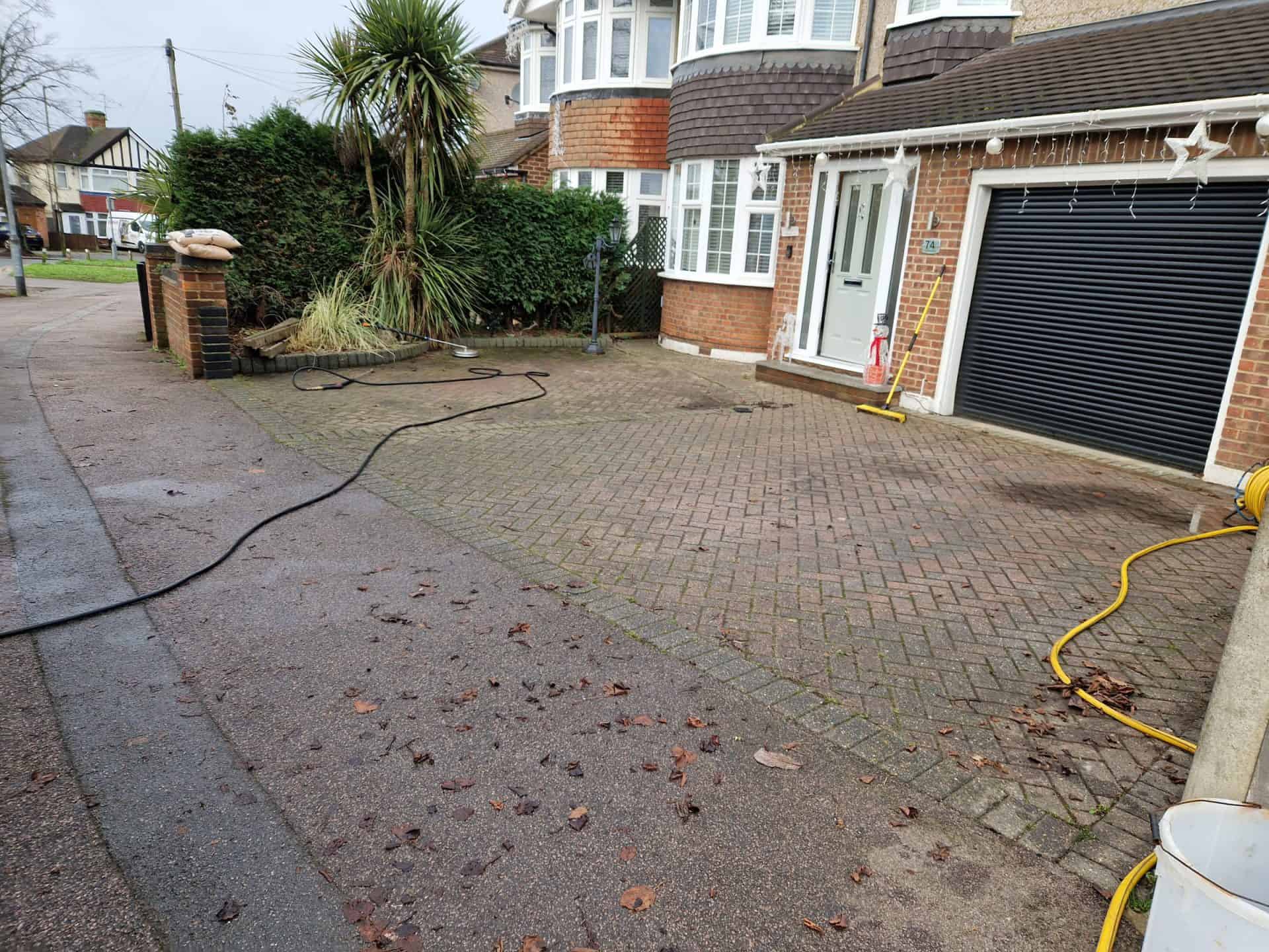 Block paved driveway before cleaning, moss and fallen leaves in the joints