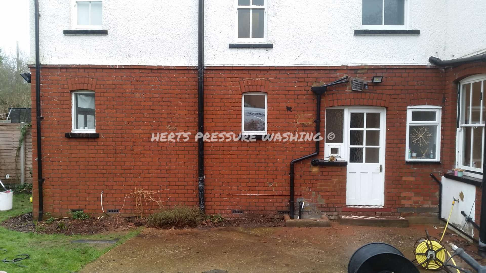 Red brick house frontage after water staining has been cleaned off the brickwork