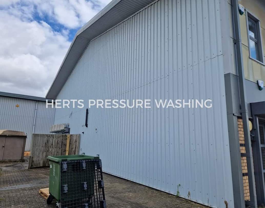 Newly pressure washed steel cladding on a commercial warehouse