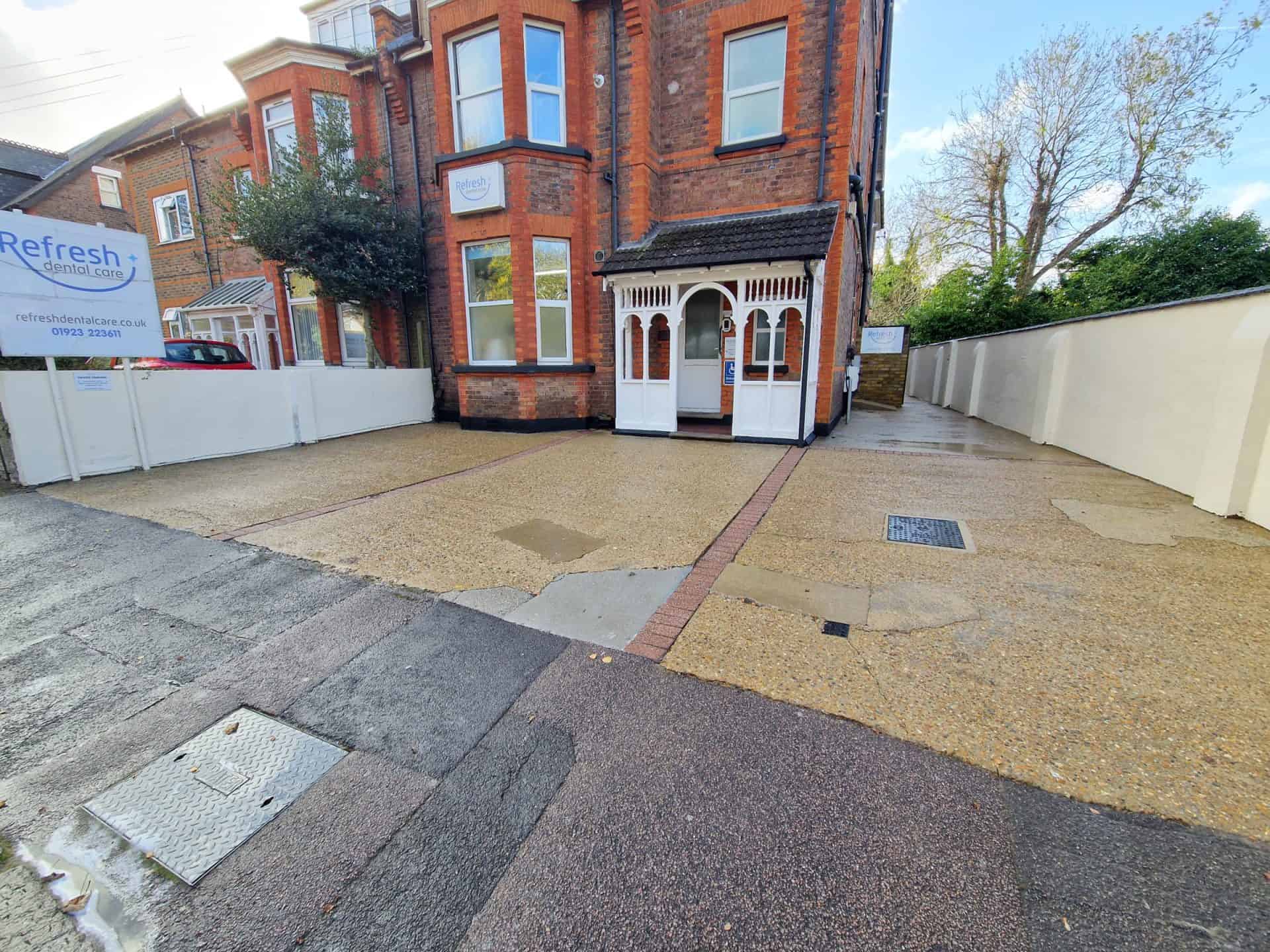 Dental practice car park after cleaning, the resin and concrete forecourt clean in front of the red brick building