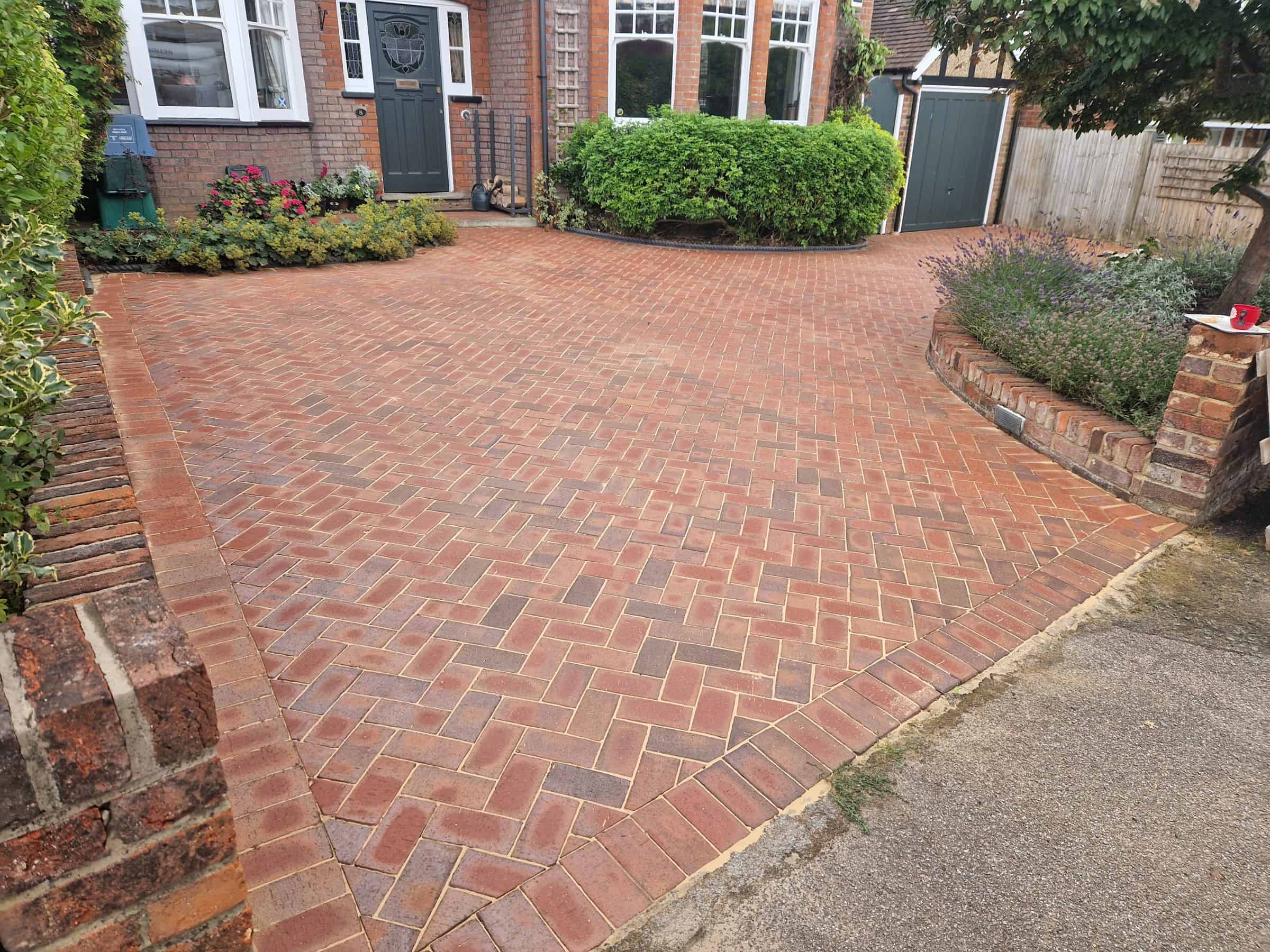 Cleaned brick-paved driveway after pressure washing