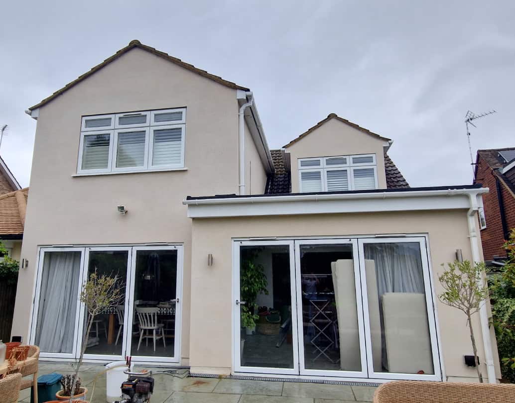 Cleaned cream render on the rear of a Hertfordshire house with a single-storey extension, after professional render cleaning