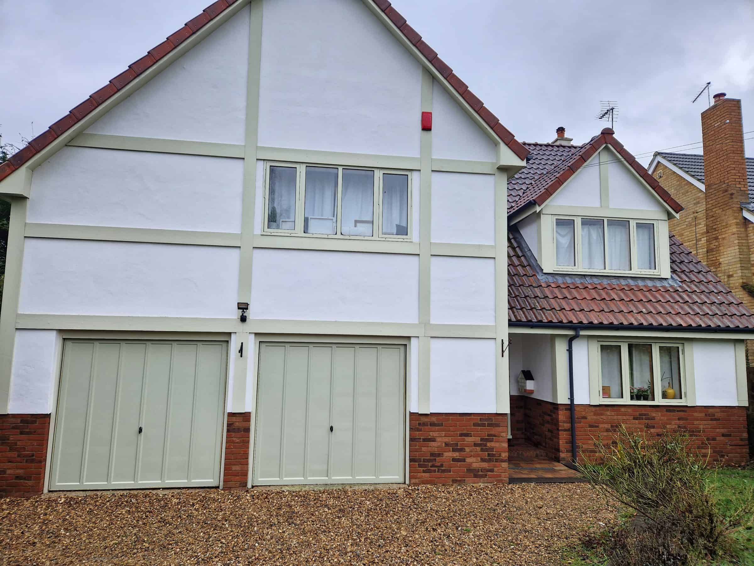 Cleaned render on the front of a mock-Tudor house in Hertfordshire after soft washing