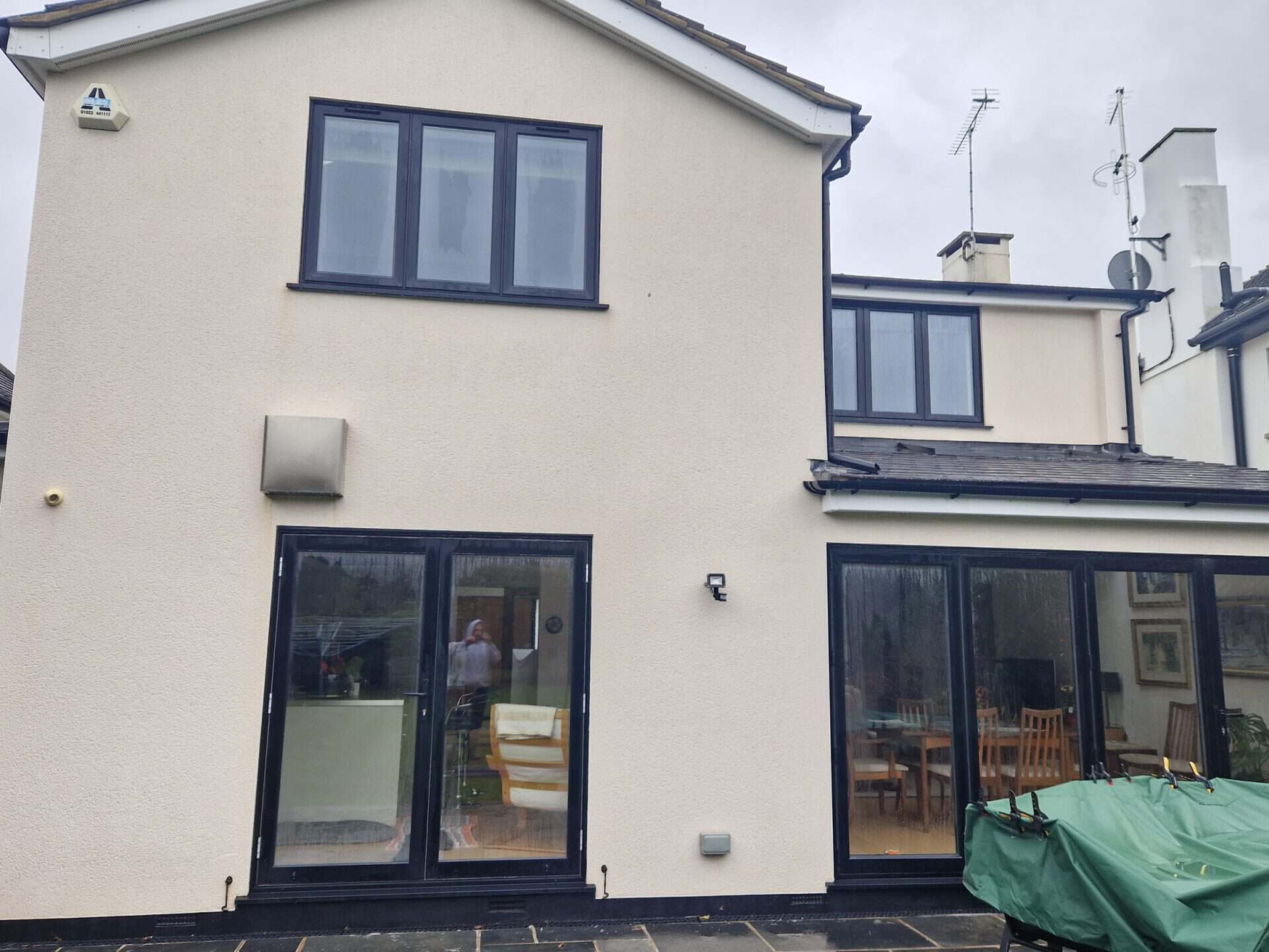 The same rendered rear extension after soft washing, the render clean and white again