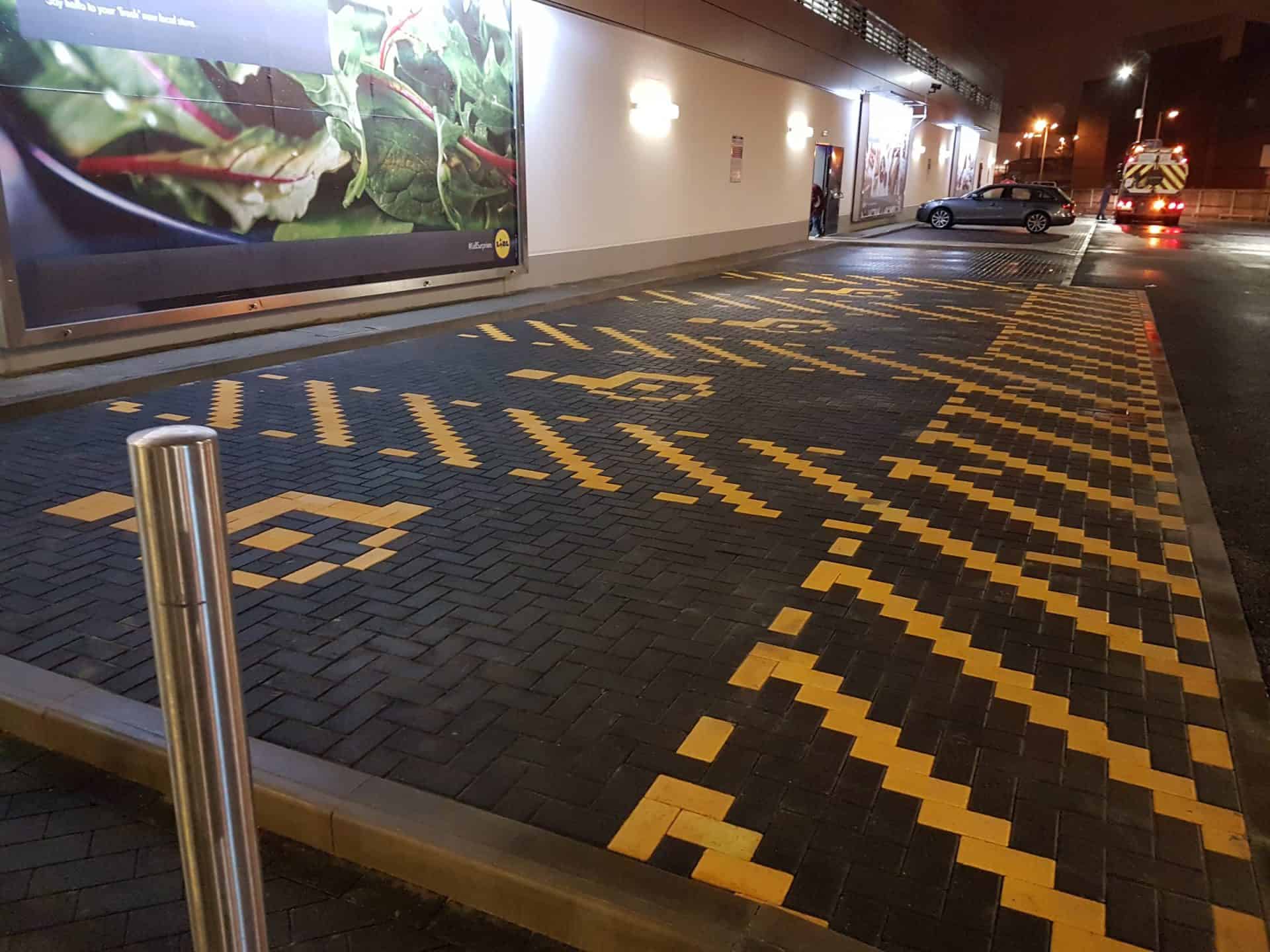 Supermarket car park with yellow-lined bays after pressure washing