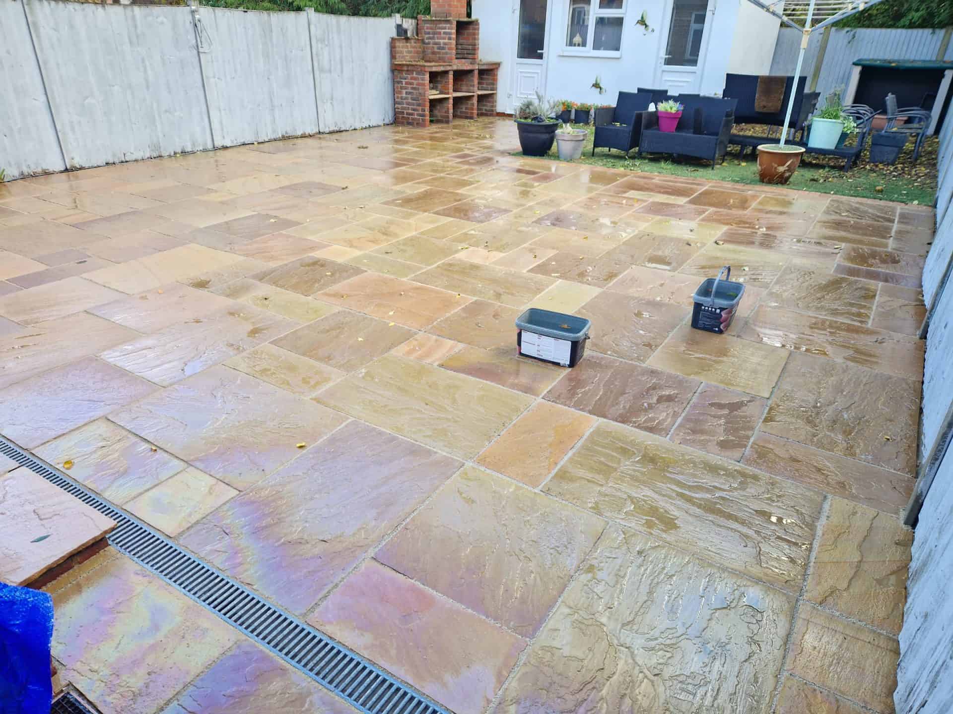 The same Indian sandstone patio in Borehamwood after cleaning and repointing, the natural colour of the stone showing again