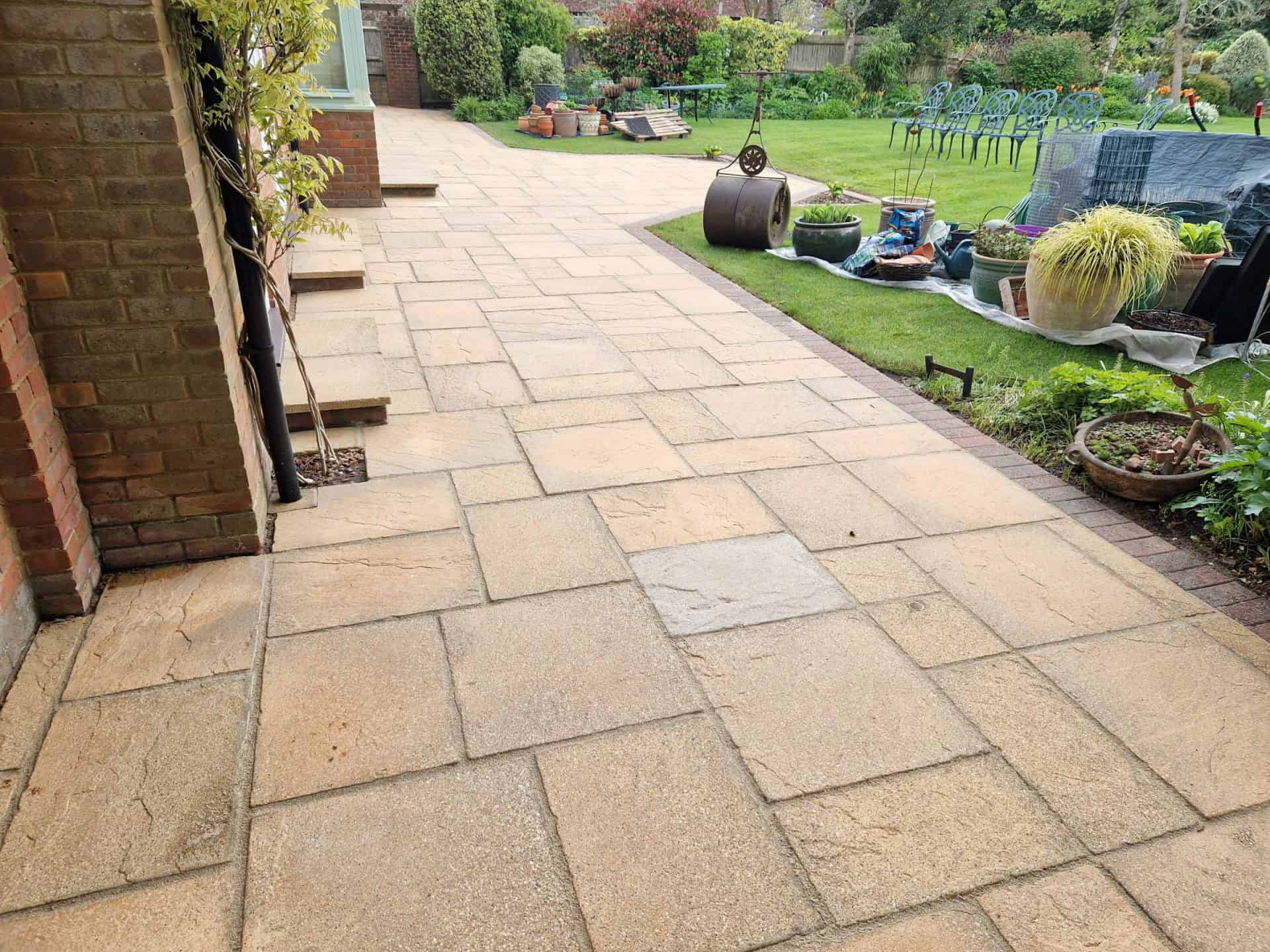 Sandstone patio in Tring part way through cleaning, cleaned section against the dirty section