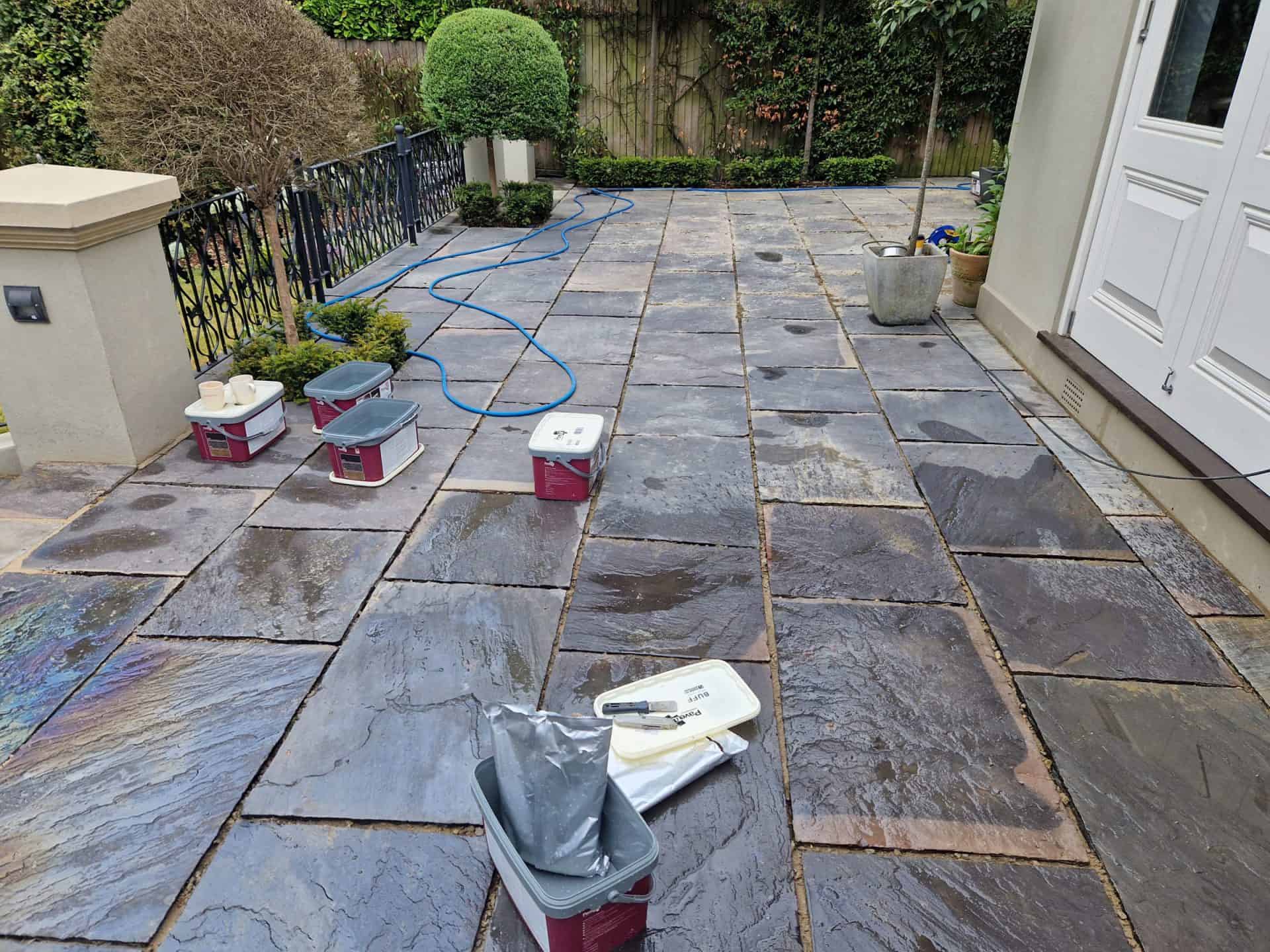Slate patio in Barnet mid-job, cleaned with the joints raked out ready for repointing