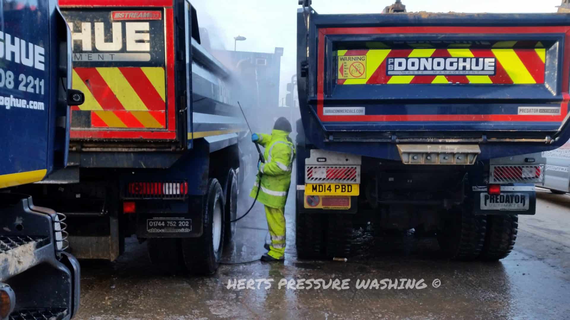 Lorry being pressure washed in a yard